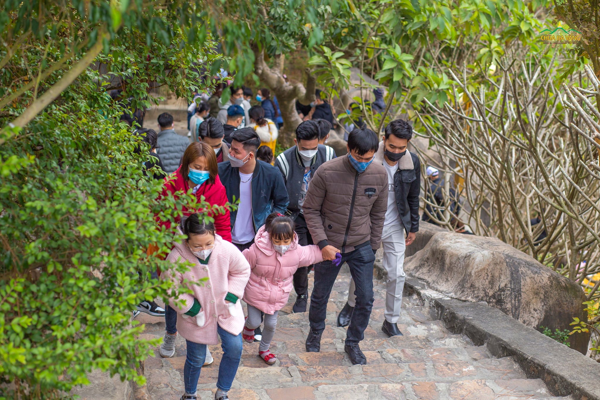 Cha mẹ dẫn các em nhỏ lên chùa đón xuân